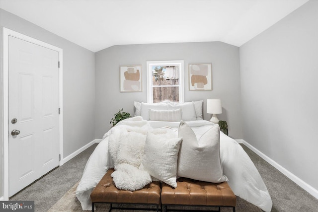 carpeted bedroom with lofted ceiling and baseboards