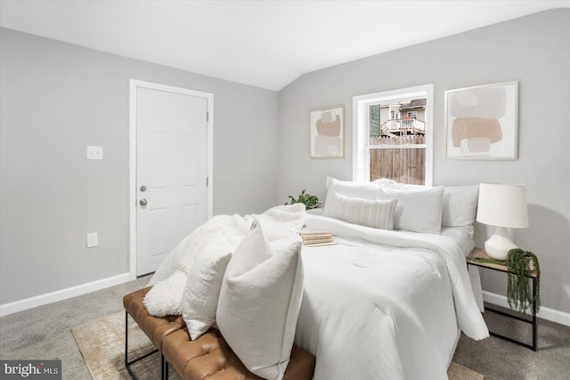 bedroom with lofted ceiling, carpet floors, and baseboards