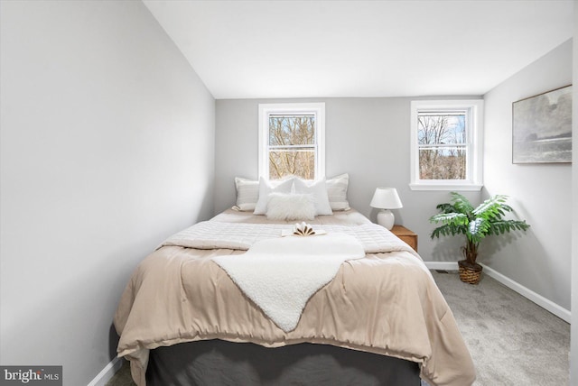 bedroom with baseboards, multiple windows, and carpet flooring