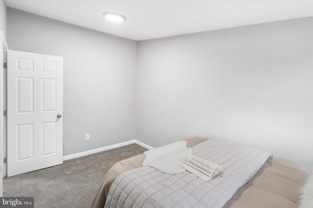 carpeted bedroom featuring baseboards