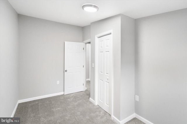 unfurnished bedroom with carpet and baseboards