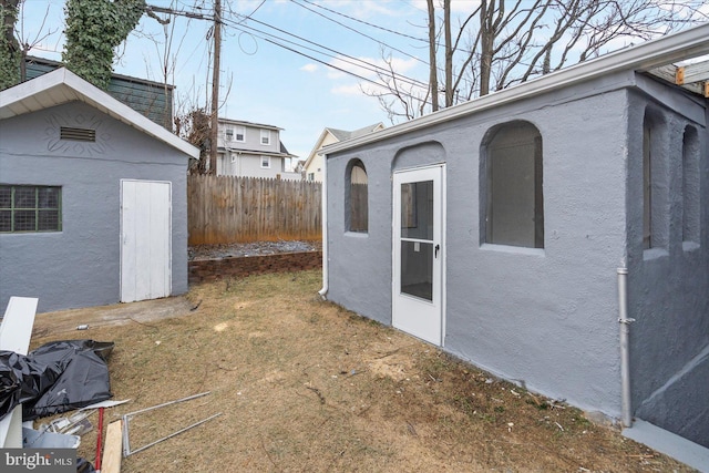 view of outbuilding with an outbuilding and fence