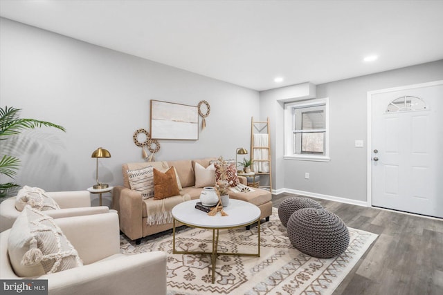 living room featuring recessed lighting, baseboards, and wood finished floors