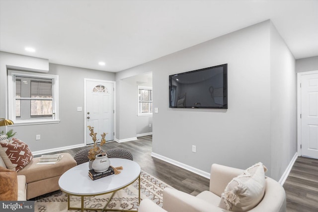 living room with baseboards, dark wood-type flooring, and recessed lighting