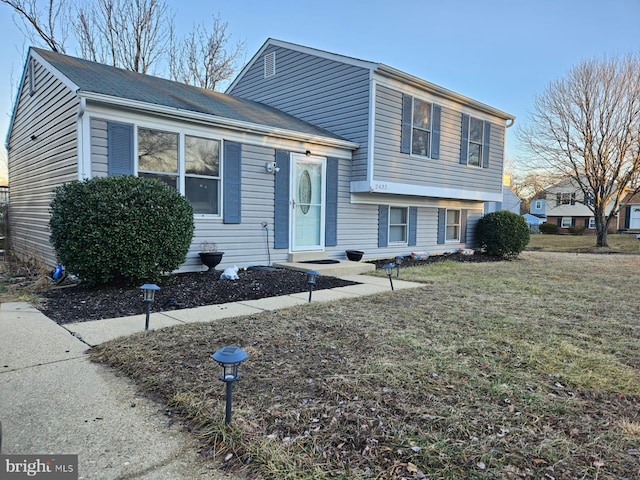 split level home featuring a front lawn