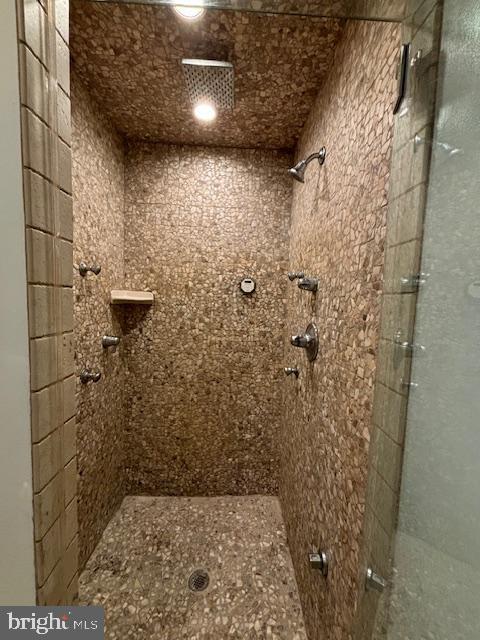 bathroom with tiled shower