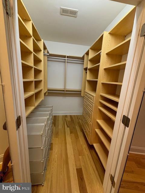 spacious closet featuring light wood-style floors and visible vents