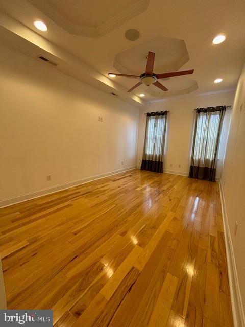 spare room with ceiling fan, recessed lighting, visible vents, baseboards, and light wood finished floors