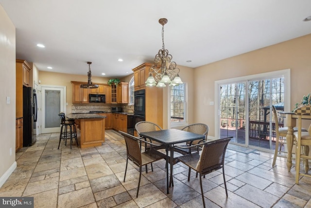 dining area with baseboards, stone tile flooring, and recessed lighting