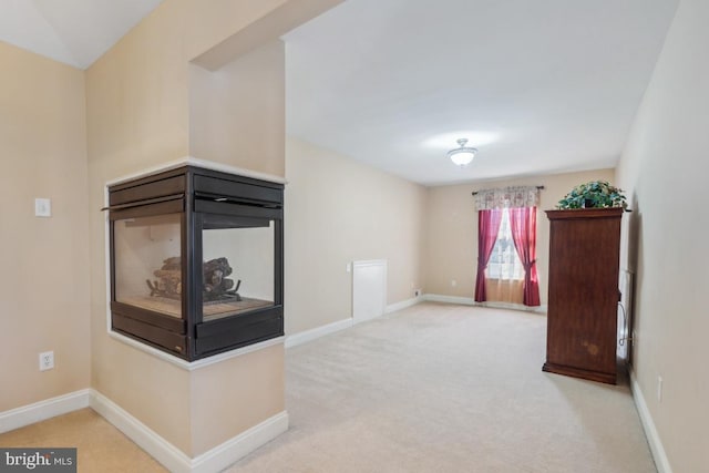 living area featuring carpet flooring and baseboards