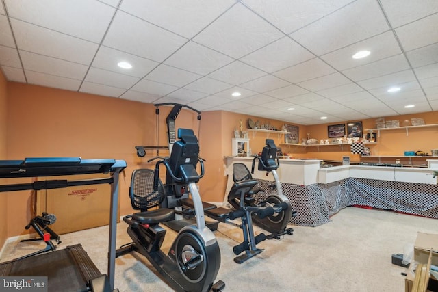 exercise area with recessed lighting, light colored carpet, and a paneled ceiling