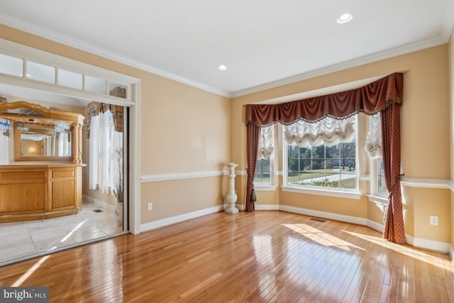 unfurnished room featuring ornamental molding, recessed lighting, baseboards, and light wood finished floors