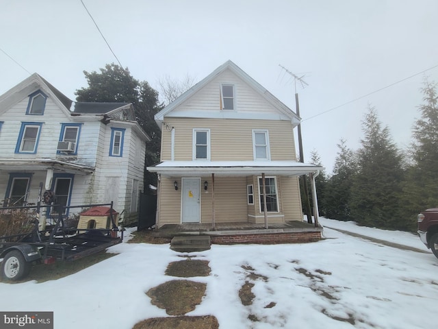 view of front of home featuring a porch and cooling unit