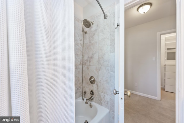 full bath with shower / tub combo and baseboards