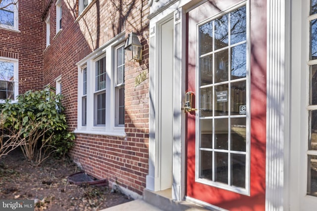 doorway to property with brick siding