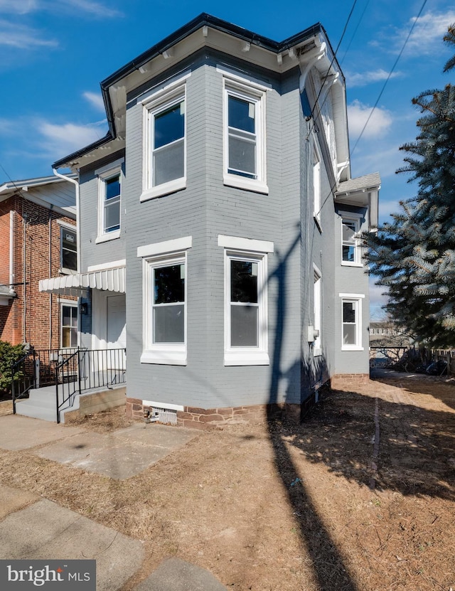 view of property exterior with brick siding