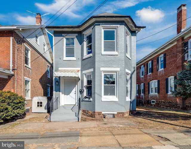 townhome / multi-family property with brick siding