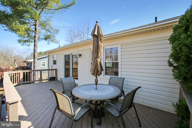 wooden deck with outdoor dining area