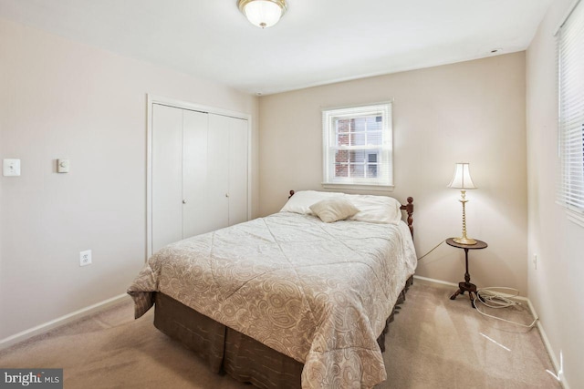 bedroom with a closet, baseboards, and carpet floors