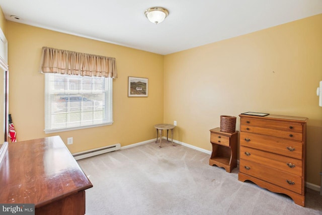 interior space featuring a baseboard heating unit, baseboards, and carpet floors