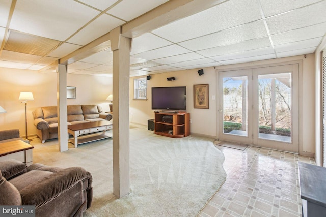 living room featuring a paneled ceiling, baseboards, and carpet floors