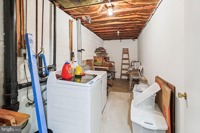 laundry area with laundry area, concrete block wall, and washer and clothes dryer