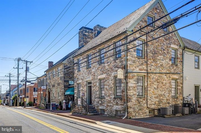 view of building exterior with central AC unit