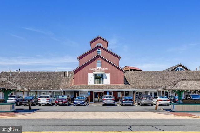 view of building exterior featuring uncovered parking