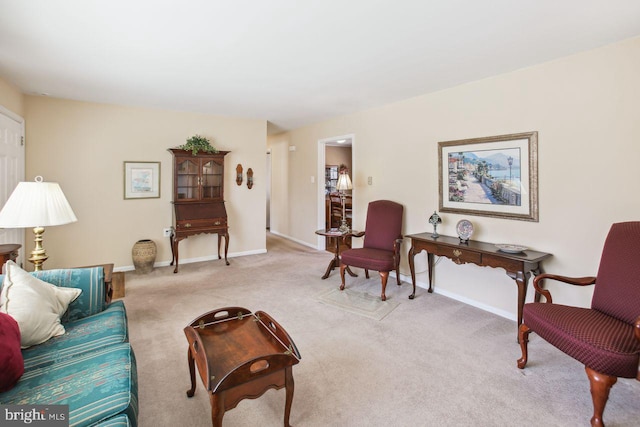 living room featuring baseboards and light colored carpet