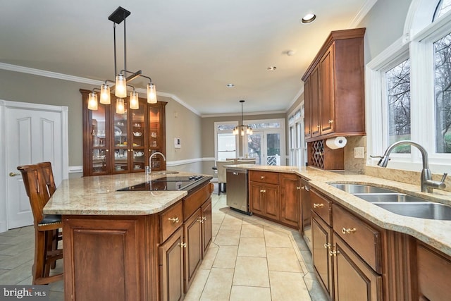 kitchen featuring crown molding, light stone countertops, decorative light fixtures, light tile patterned floors, and a sink