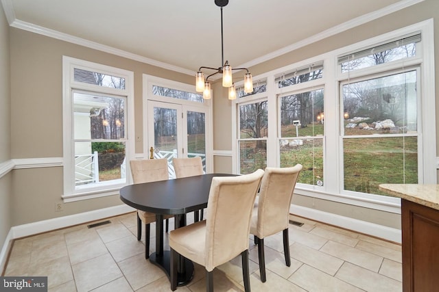 sunroom / solarium with visible vents, plenty of natural light, and an inviting chandelier