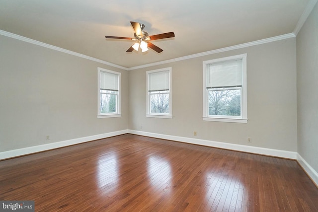 unfurnished room featuring ceiling fan, dark wood-style floors, baseboards, and ornamental molding