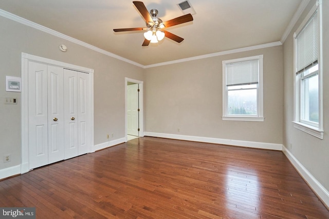 unfurnished bedroom with hardwood / wood-style flooring, baseboards, visible vents, and ornamental molding