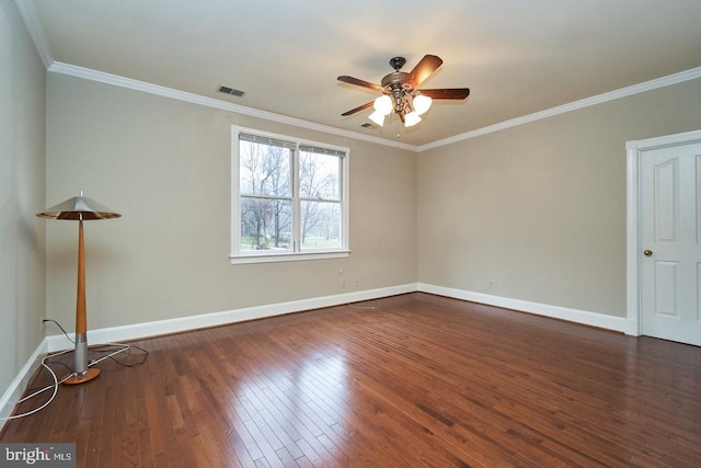 spare room featuring visible vents, crown molding, baseboards, and hardwood / wood-style flooring