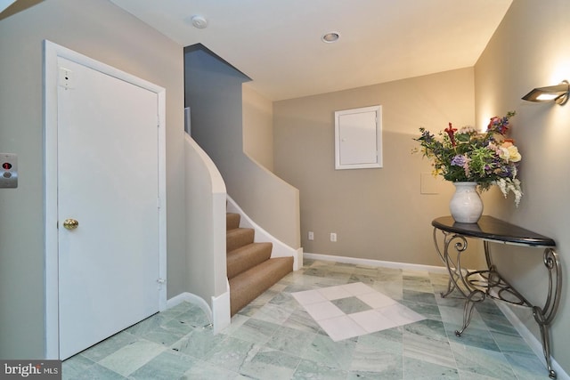 foyer with stairway and baseboards