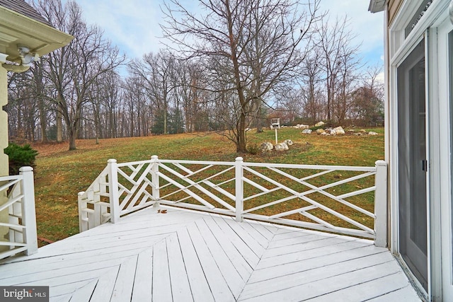 wooden deck with a lawn