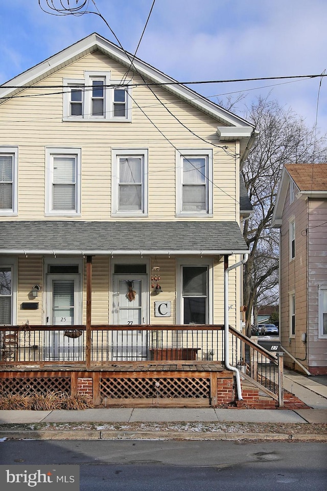 view of front of house with a porch and roof with shingles