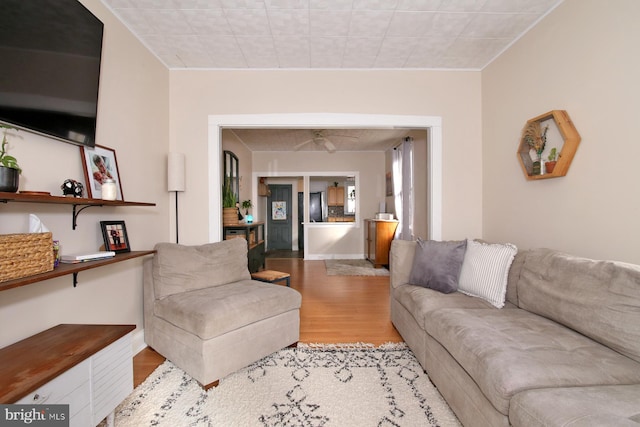 living room featuring light wood finished floors and baseboards