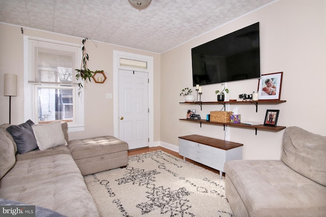 living area with light wood-style flooring and baseboards