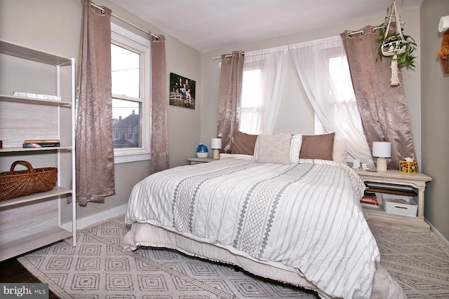 bedroom with multiple windows and baseboards