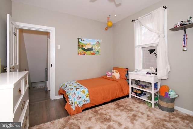 bedroom featuring dark wood-style floors, baseboards, and a ceiling fan