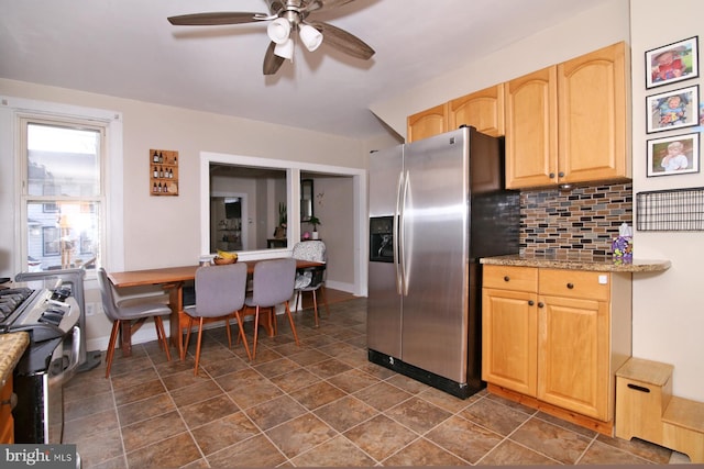 kitchen featuring tasteful backsplash, baseboards, stainless steel appliances, and a ceiling fan