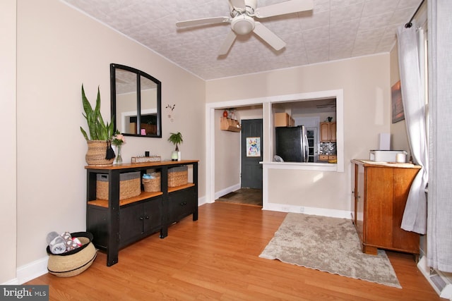 interior space featuring light wood-style flooring and baseboards