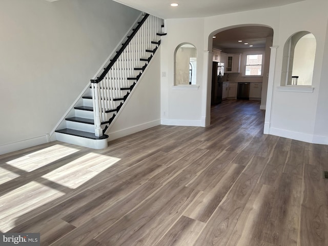 interior space with recessed lighting, dark wood-style flooring, stairway, and baseboards