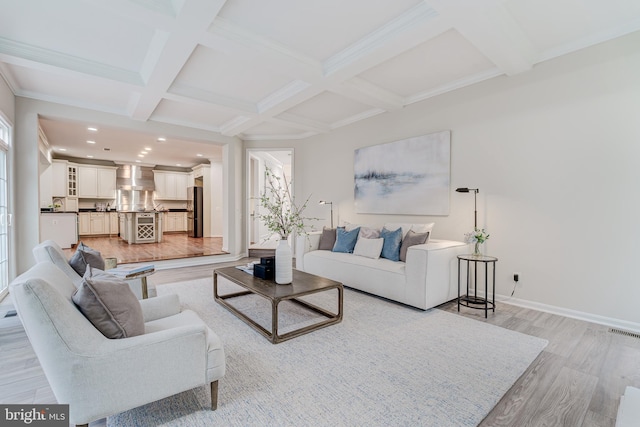 living room featuring light wood-style floors, beam ceiling, coffered ceiling, and baseboards