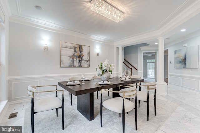 dining space featuring marble finish floor, visible vents, a decorative wall, and ornate columns