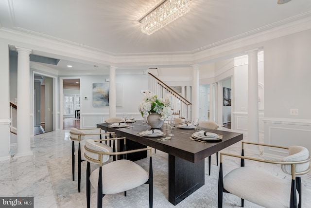 dining space featuring decorative columns, stairs, and a decorative wall