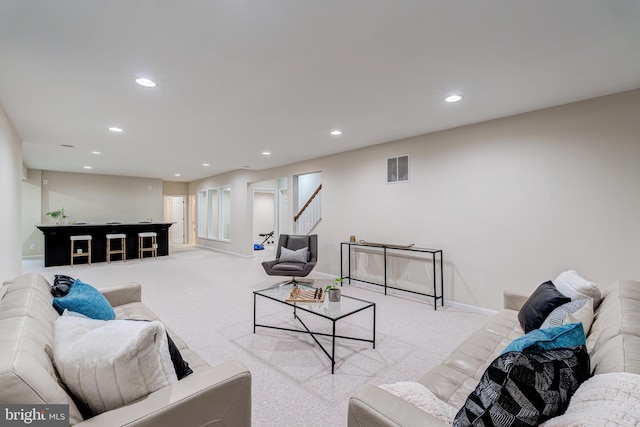 living room featuring carpet, visible vents, baseboards, and recessed lighting