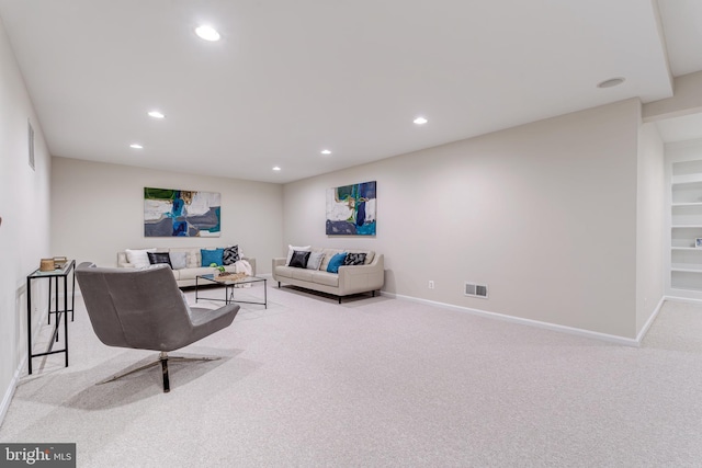 carpeted living area featuring baseboards, visible vents, and recessed lighting