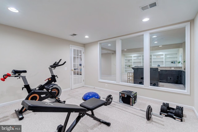 workout room with carpet, baseboards, and visible vents